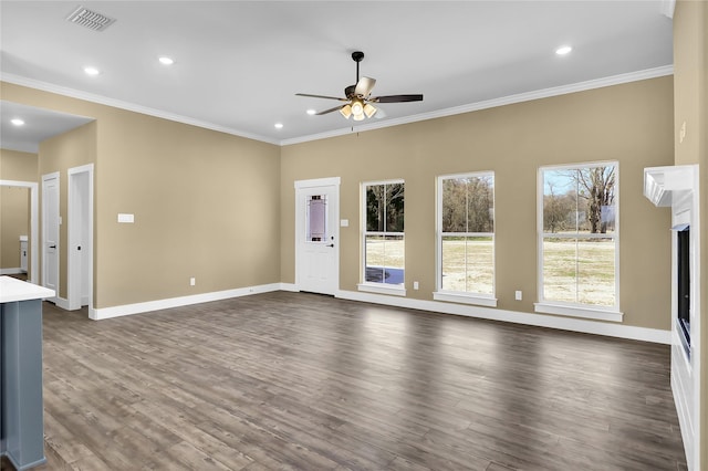 unfurnished living room featuring ornamental molding, ceiling fan, and dark hardwood / wood-style flooring