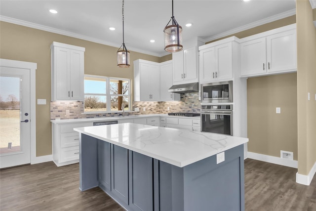 kitchen featuring decorative light fixtures, oven, and white cabinets