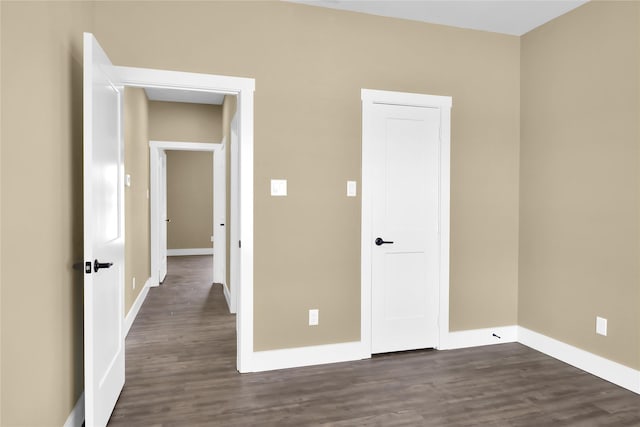 unfurnished bedroom featuring dark hardwood / wood-style flooring