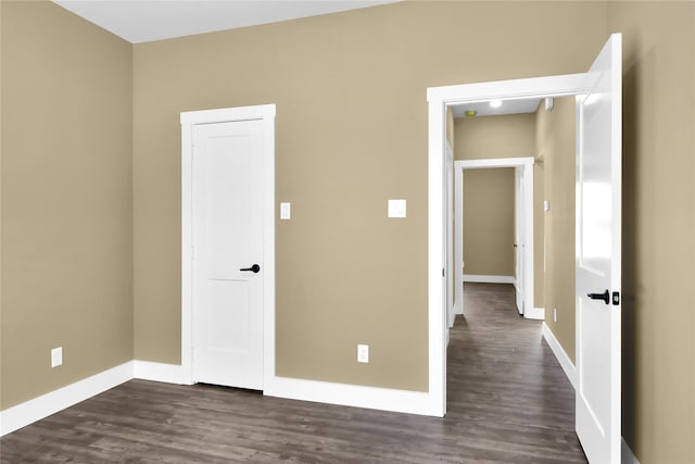 unfurnished bedroom featuring dark wood-type flooring