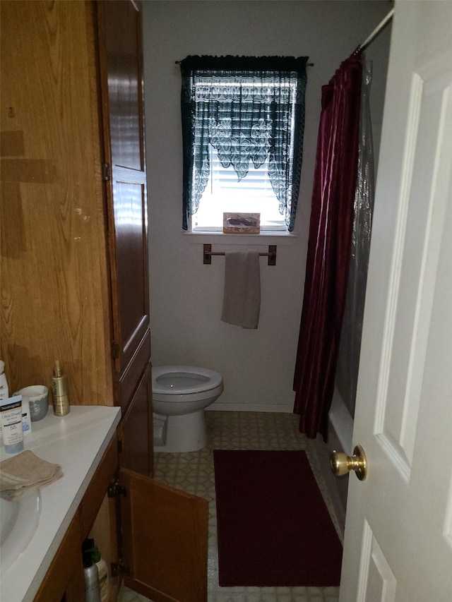 full bathroom with vanity, toilet, and shower / bath combo with shower curtain