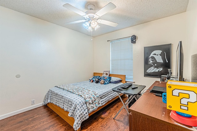 bedroom featuring ceiling fan, dark wood-type flooring, and a textured ceiling