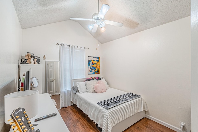 bedroom with dark hardwood / wood-style floors, vaulted ceiling, and a textured ceiling