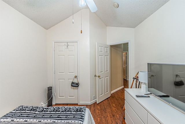 bedroom featuring ceiling fan, lofted ceiling, a textured ceiling, and dark hardwood / wood-style flooring