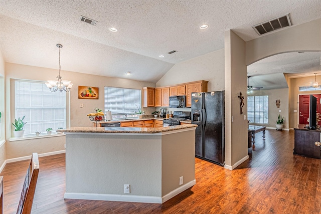 kitchen with wood-type flooring, vaulted ceiling, plenty of natural light, pendant lighting, and black appliances