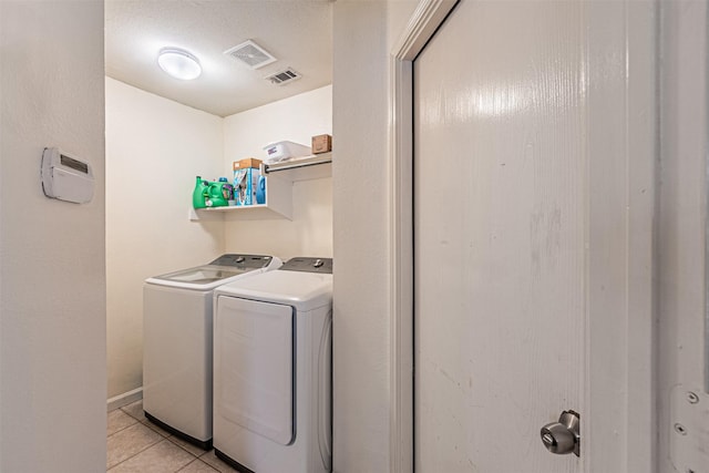 laundry room featuring light tile patterned floors and washer and dryer