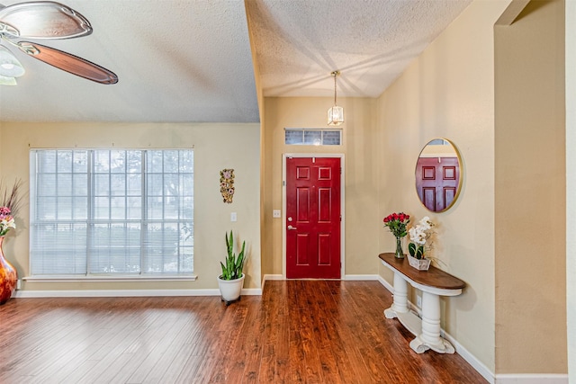 foyer with ceiling fan, dark hardwood / wood-style floors, and a textured ceiling