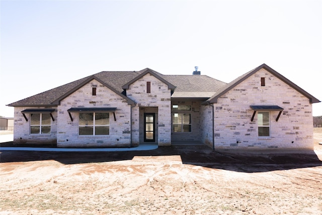 view of front of property with roof with shingles