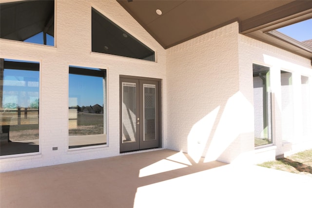 entrance to property featuring french doors and a patio area