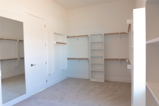 walk in closet featuring light carpet