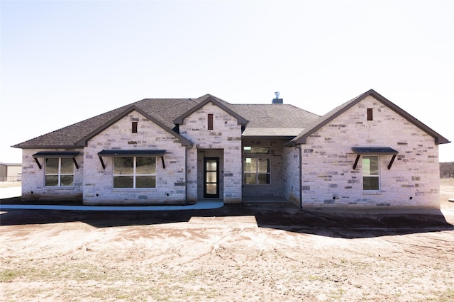 view of front of house featuring roof with shingles