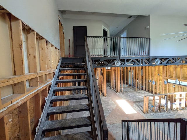 stairway with vaulted ceiling