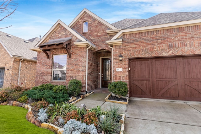 3023 Seattle Slew Dr, Celina, TX 75009 - view of front of house with brick siding, driveway, a shingled roof, and an attached garage