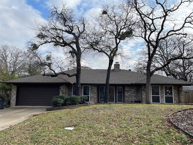 ranch-style house featuring a garage and a front yard