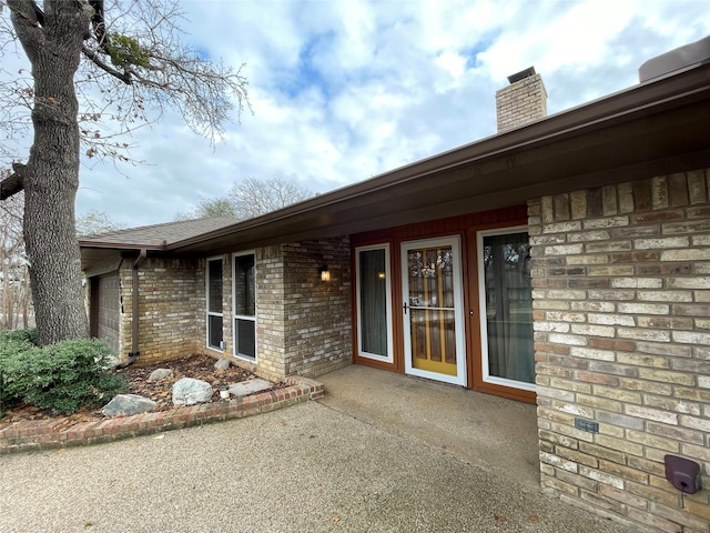 entrance to property featuring a patio