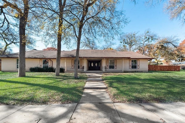 ranch-style home featuring a front yard