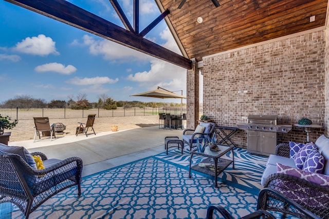 view of patio featuring ceiling fan, a grill, an outdoor hangout area, and a rural view