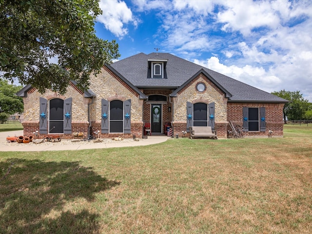 french country home featuring a front yard