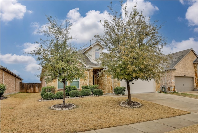 view of front of house with a garage and a front lawn