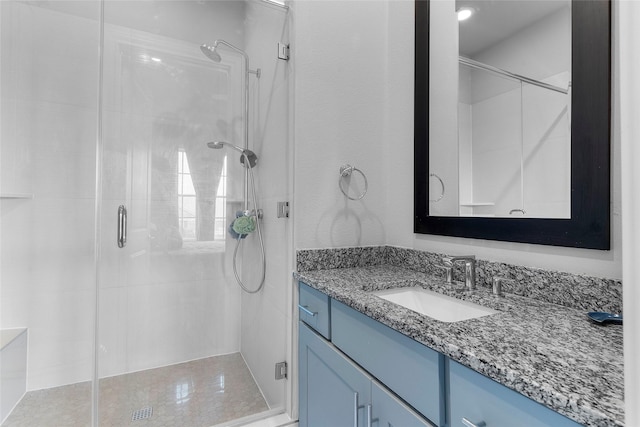 bathroom featuring vanity and a shower with shower door