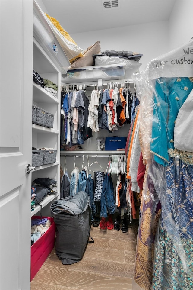 spacious closet featuring hardwood / wood-style floors