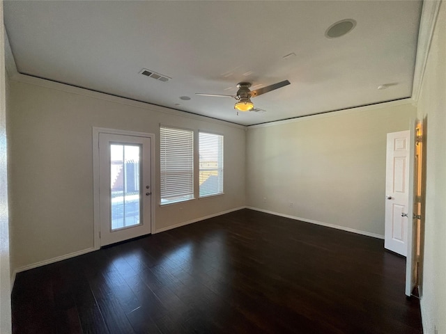 empty room with ceiling fan, ornamental molding, and dark hardwood / wood-style floors