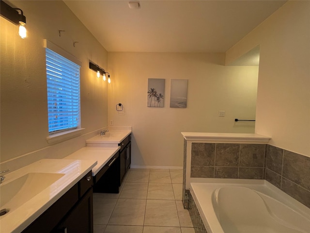 bathroom with tile patterned floors, vanity, and tiled tub