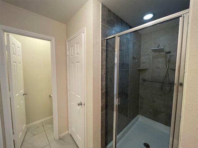 bathroom featuring walk in shower and tile patterned floors