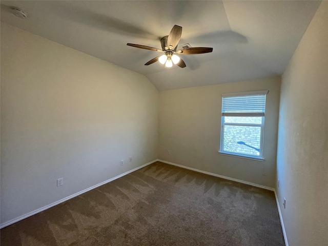 carpeted empty room featuring ceiling fan and lofted ceiling