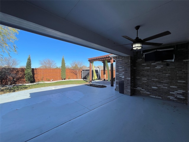 view of patio featuring a storage shed, a pergola, and ceiling fan