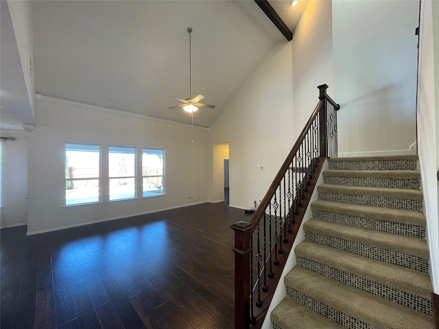 stairway with hardwood / wood-style flooring, ceiling fan, and high vaulted ceiling