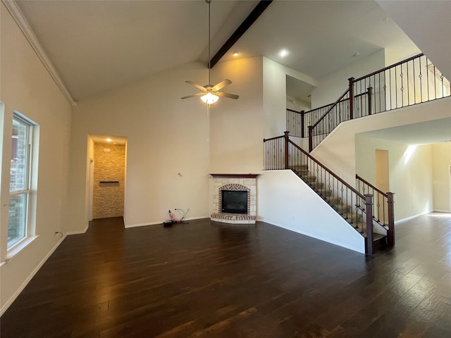 unfurnished living room featuring beamed ceiling, a brick fireplace, dark hardwood / wood-style floors, and high vaulted ceiling