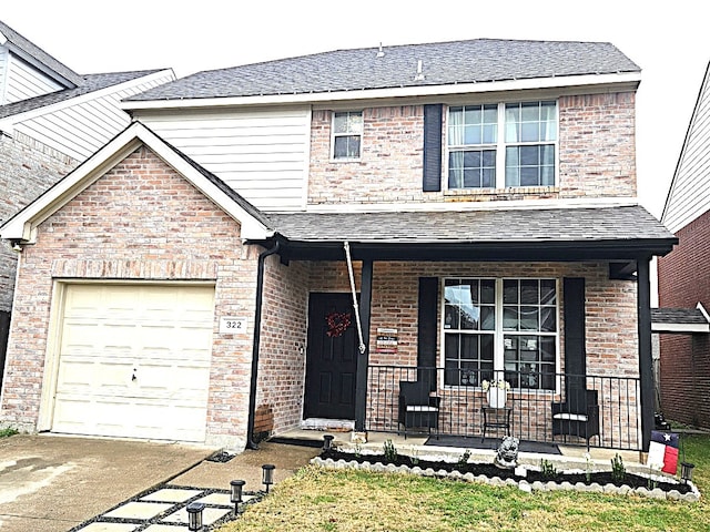 view of front property featuring a porch and a garage