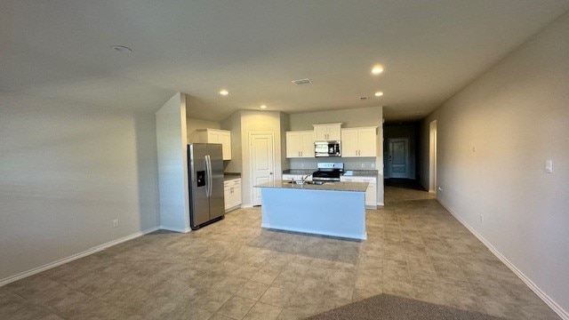 kitchen featuring white cabinetry, an island with sink, and appliances with stainless steel finishes