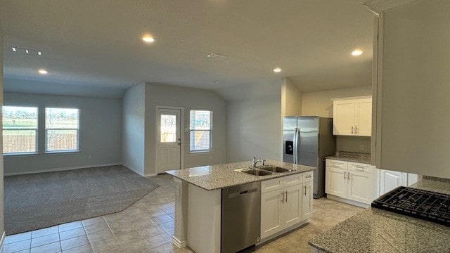 kitchen with sink, an island with sink, a wealth of natural light, stainless steel appliances, and white cabinets