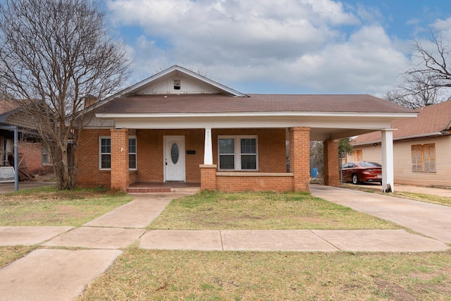 view of front of property with a carport, covered porch, and a front yard