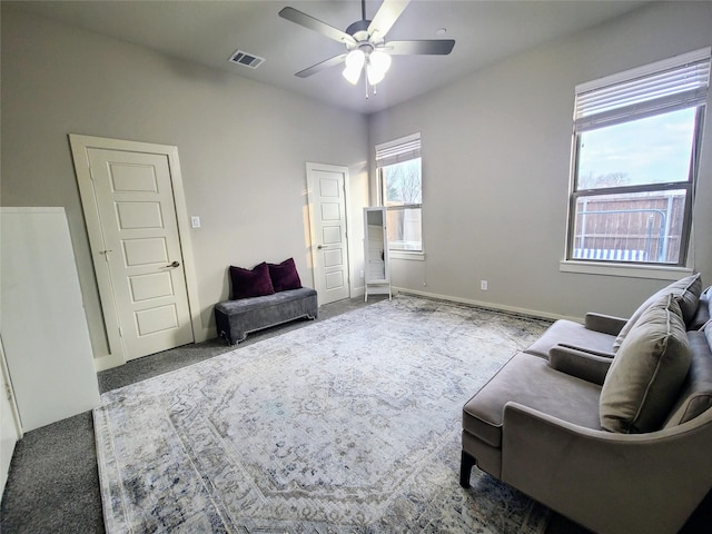 living area featuring ceiling fan and carpet floors