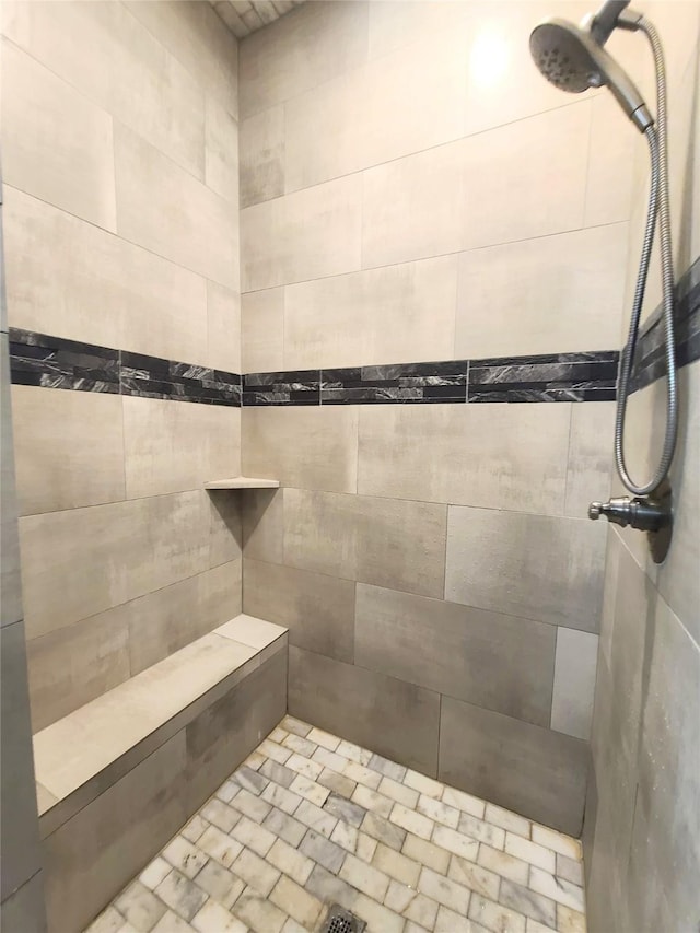 bathroom with tiled shower