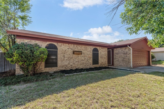 ranch-style house with a garage and a front yard