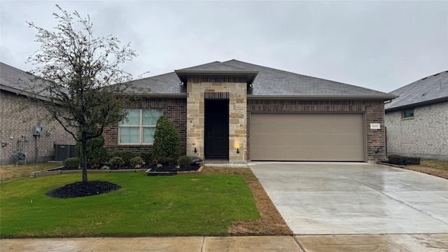 view of front facade with central AC unit, a garage, and a front yard