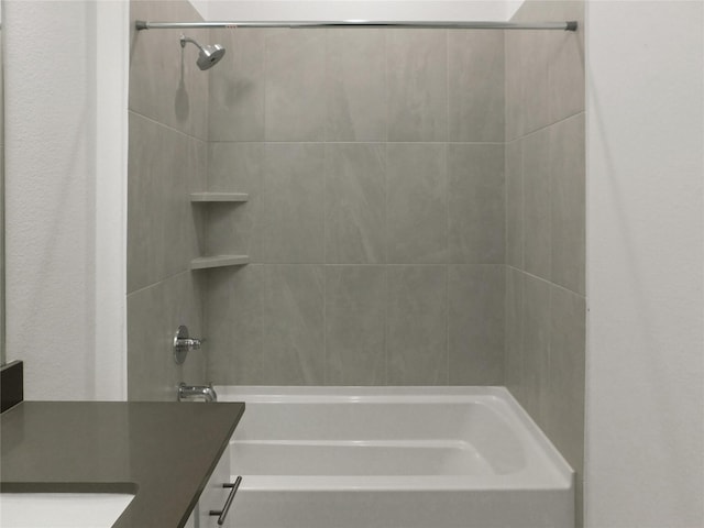 bathroom featuring vanity and tiled shower / bath