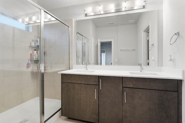 bathroom with vanity and a shower with shower door