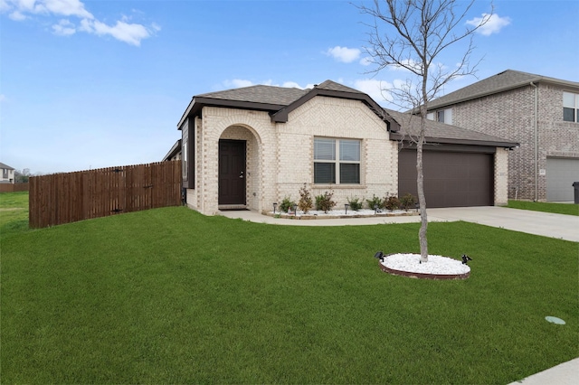 view of front of home with a garage and a front lawn