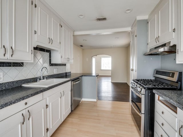 kitchen featuring stainless steel appliances, white cabinetry, sink, and decorative backsplash