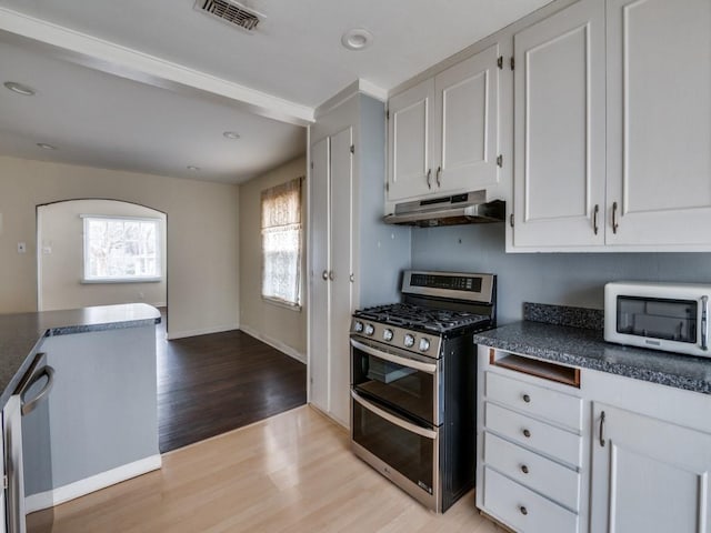 kitchen with white cabinetry, stainless steel appliances, and light wood-type flooring