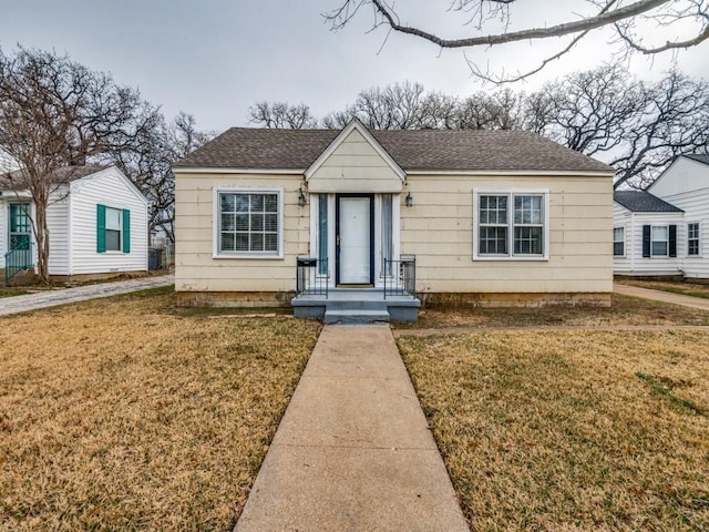 bungalow-style house featuring a front yard