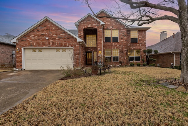 front of property featuring a yard and a garage