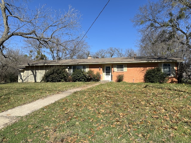 ranch-style home with a front lawn