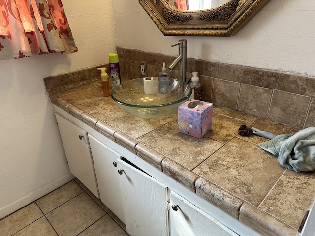 bathroom featuring tile patterned flooring and vanity