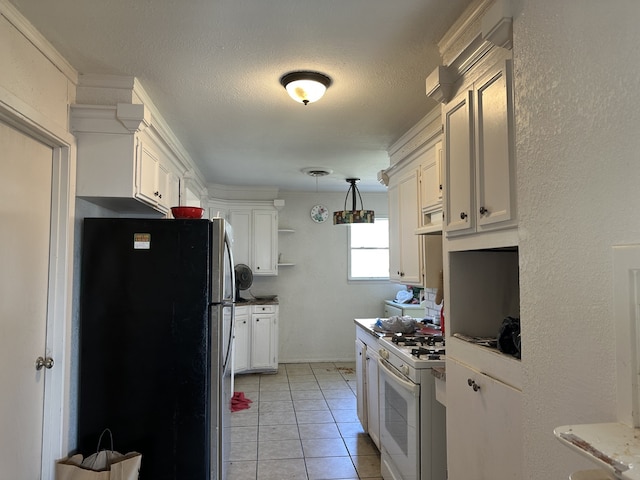 kitchen featuring white cabinetry, pendant lighting, white range with gas stovetop, and stainless steel refrigerator